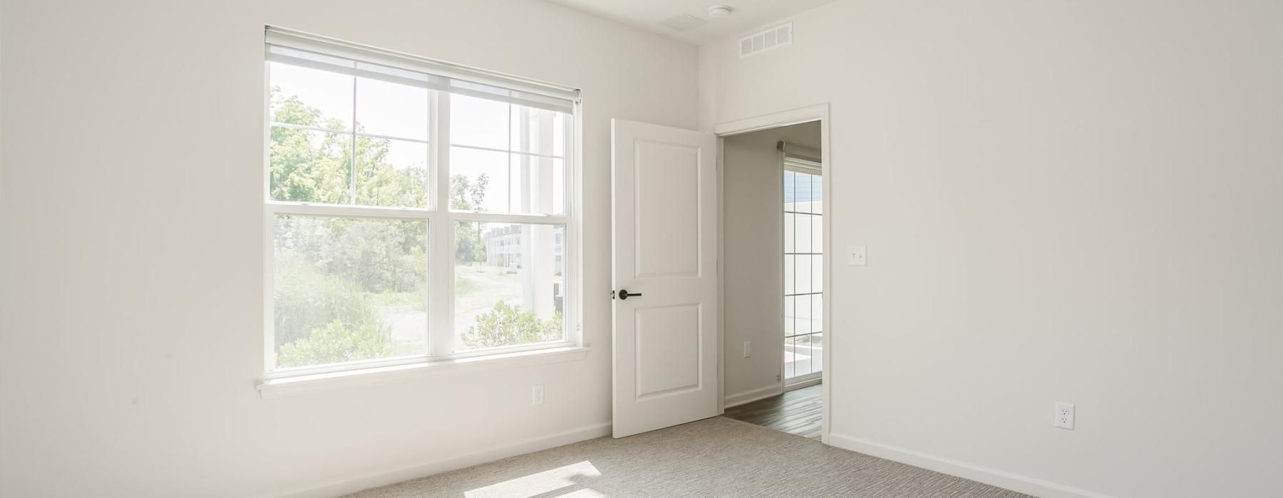 a room with a ceiling fan and a window